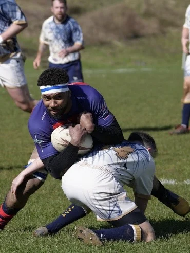 Adam Wade puts the tackle in. Ventnor v USP 140326. Photo by Luke Butler