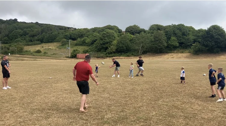 Future players are coached during the halftime break