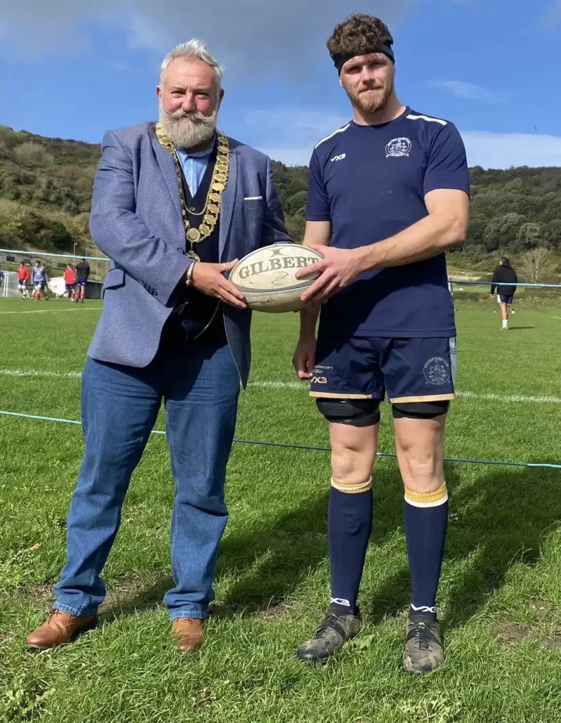 Steve Cooper, Ventnor's Mayor, presents the match ball to Lewy Morton, Ventnor's Captain